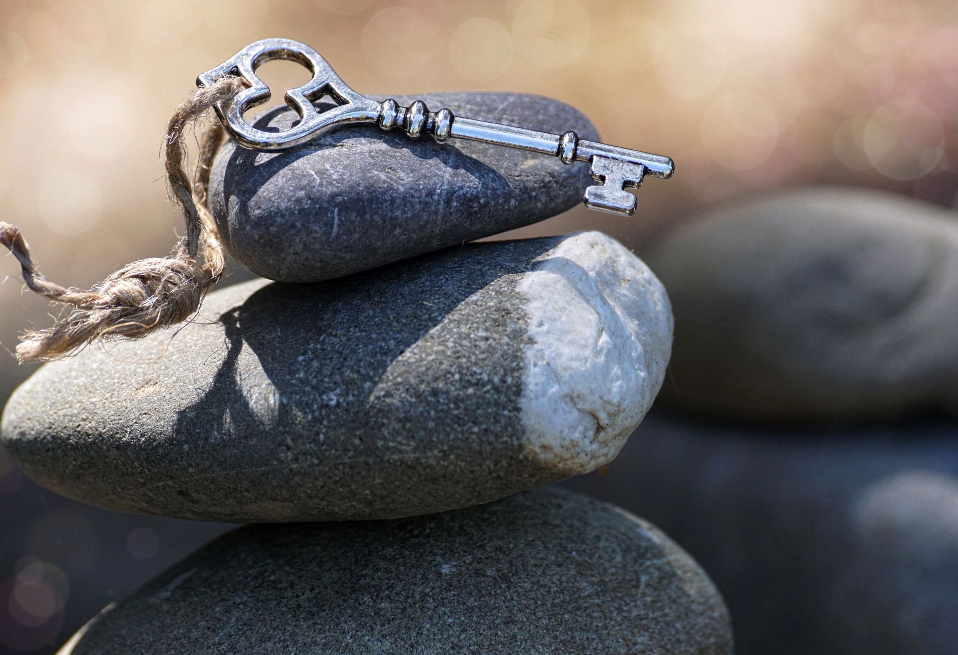 Image showing smooth stones piled with a key placed on top