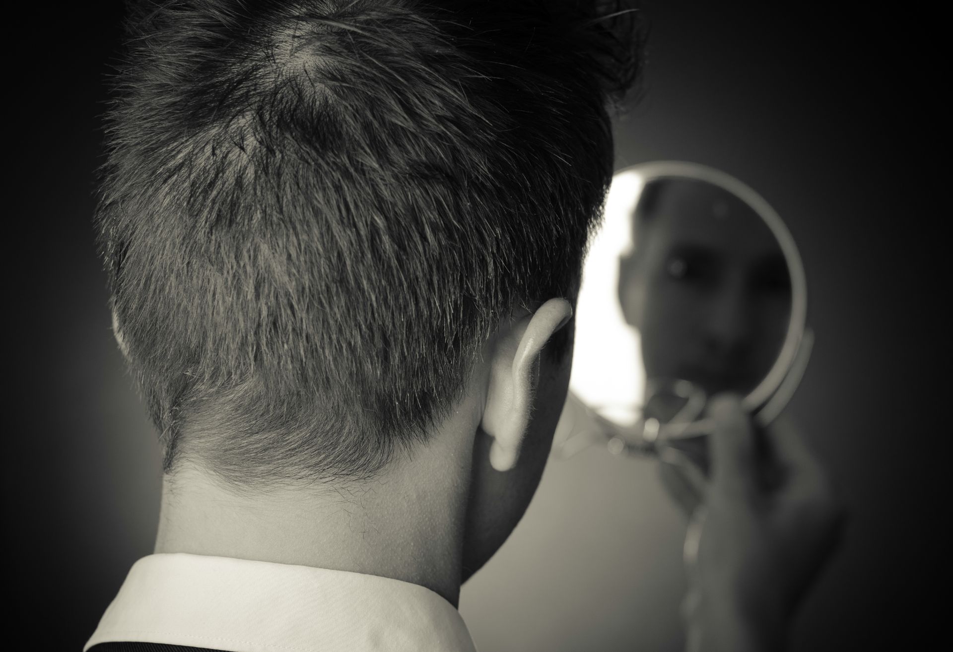 Image of a man looking into a mirror